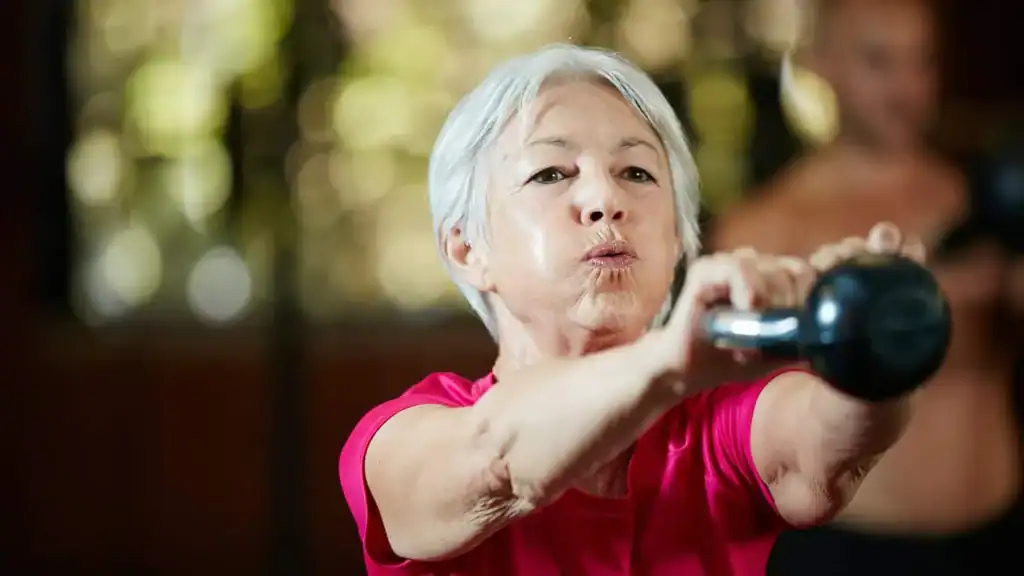 Older woman doing weight training York to help her strength and longevity 